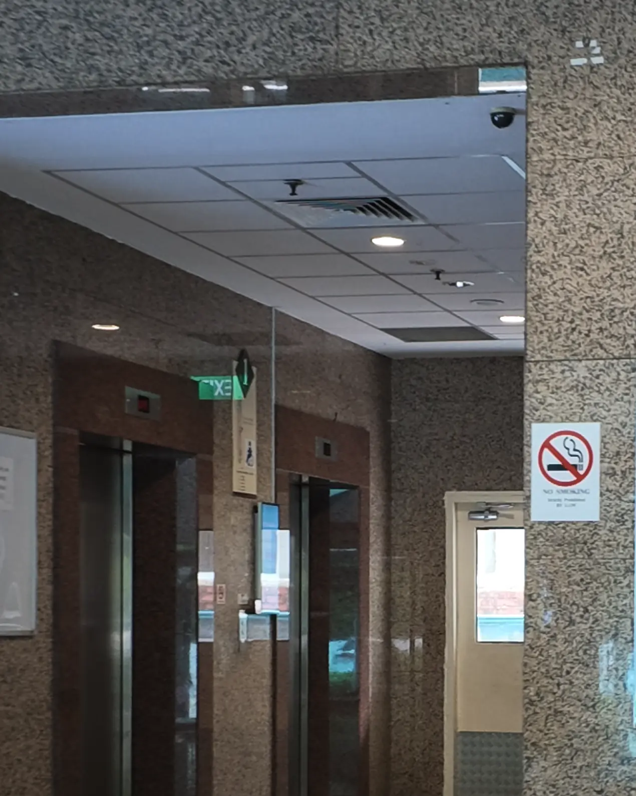 The granite lift lobby inside Balmoral Plaza, with lifts to level 3