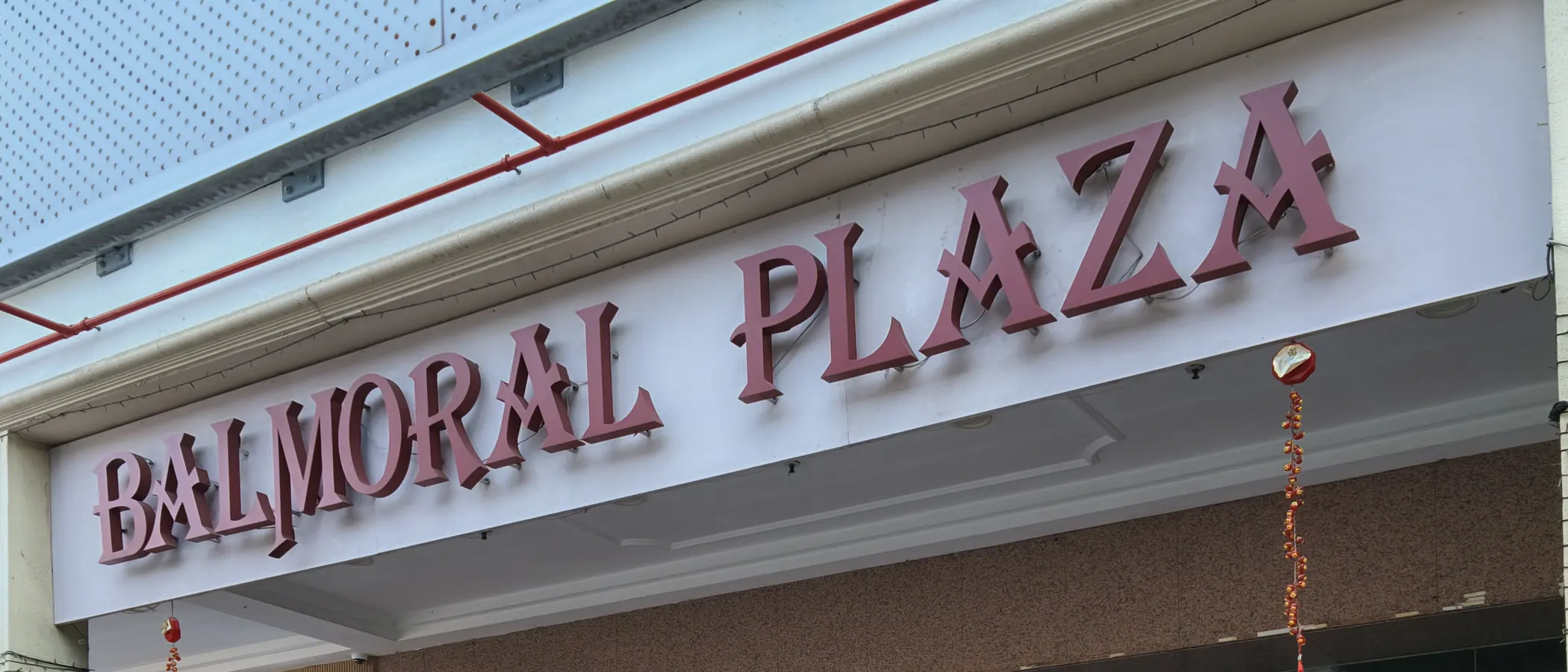 The BALMORAL PLAZA lettering above the main entrance on Bukit Timah Road