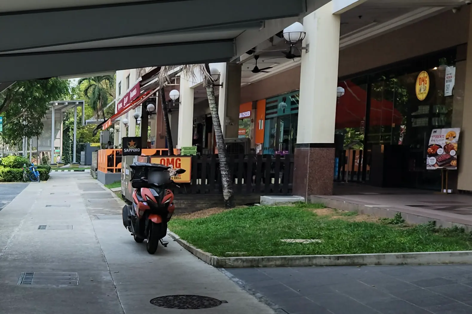 The covered walkway along the Balmoral Plaza shopfronts, leading to the main entrance