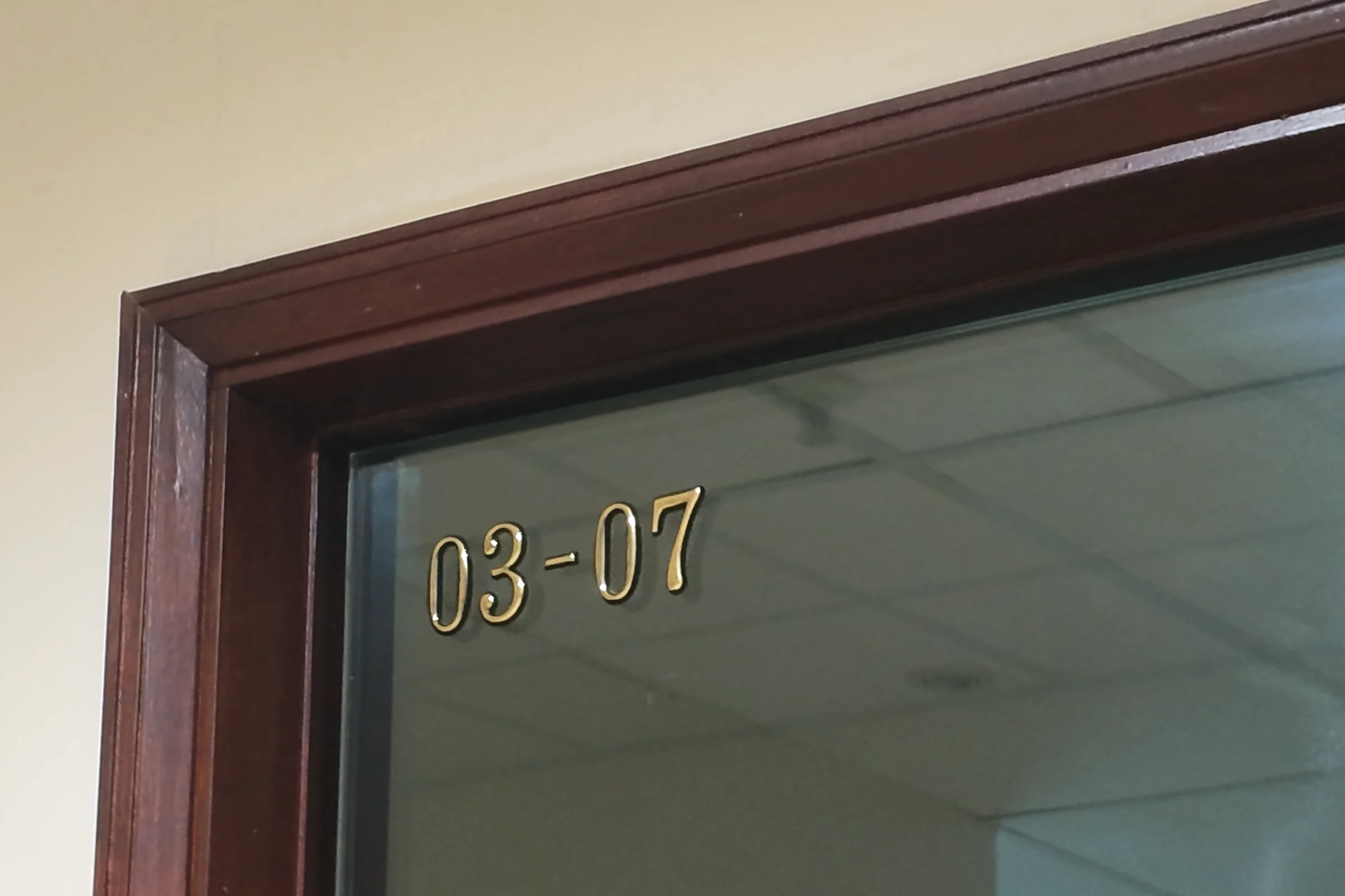 Gold numerals 03-07 on the glass door of The Study Suite at Balmoral Plaza